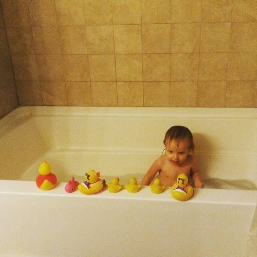 Non-Professional plays in baths with a toy
