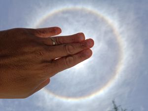 Hand Framing a Solar Halo